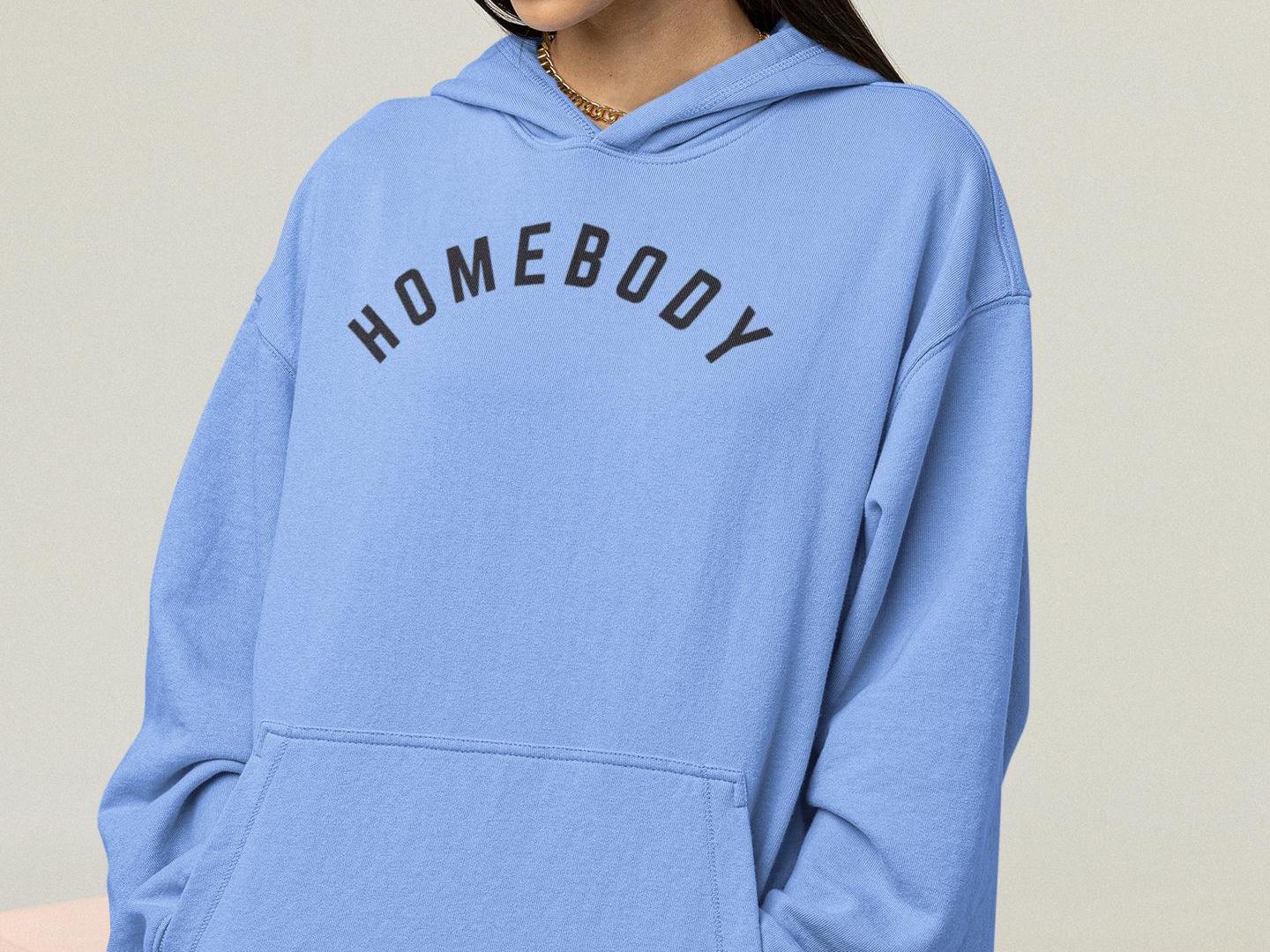 a woman wearing a blue hoodie that says homeboy