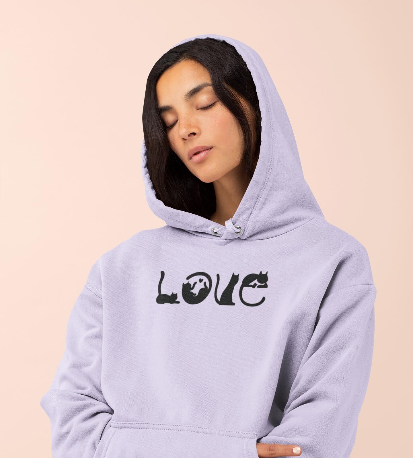 a woman wearing a hoodie with the word love printed on it