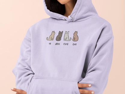 a woman wearing a purple hoodie with cats on it